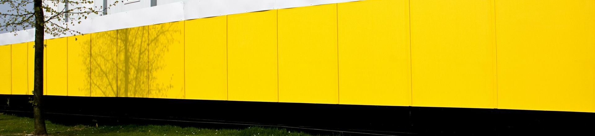 CS Hoardings and Fencing yellow painted site hoarding